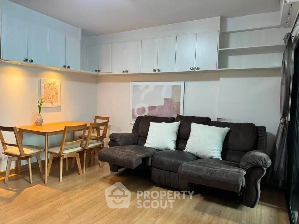 Cozy living room with modern furniture and stylish decor in a well-lit apartment.