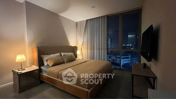 Luxurious bedroom with city view, modern furnishings, and ambient lighting for a cozy atmosphere.