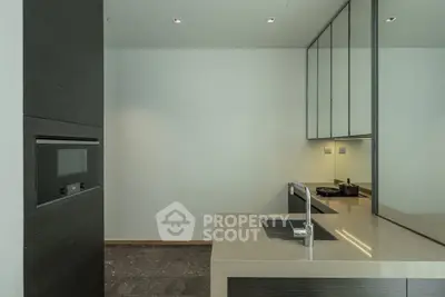 Modern minimalist kitchen with sleek design and integrated appliances.