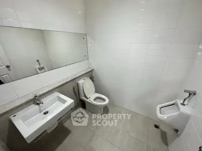 Modern bathroom with sleek white tiles and contemporary fixtures
