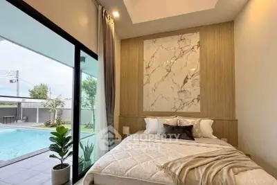 Luxurious bedroom with pool view and elegant decor in modern home
