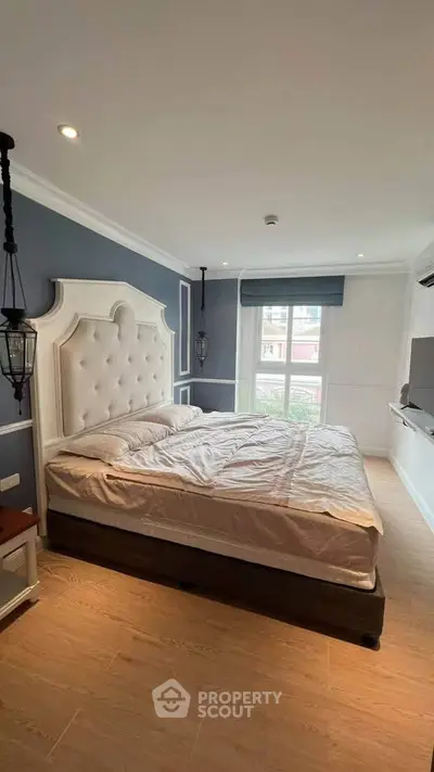 Elegant bedroom with plush headboard and natural light