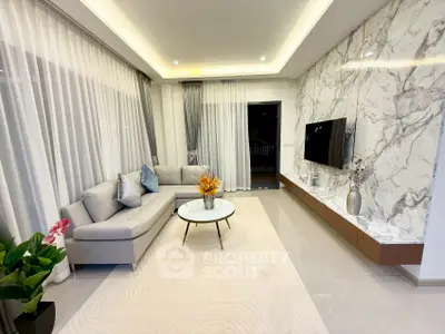 Luxurious modern living room with marble accent wall and sleek furniture
