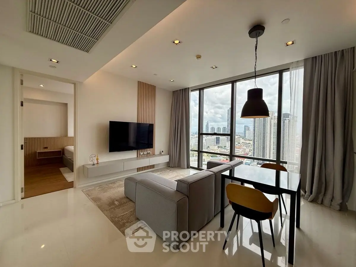 Modern living room with city view, sleek furniture, and open layout in high-rise apartment.