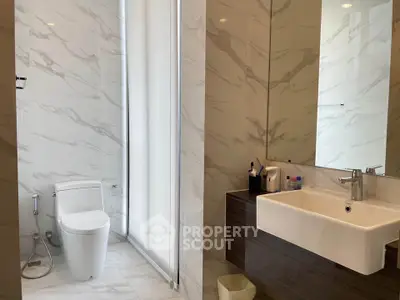 Modern bathroom with sleek fixtures and marble tiles