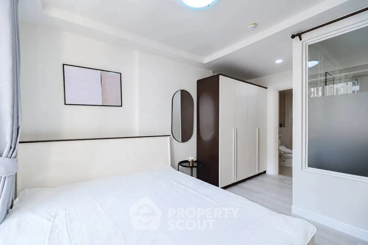 Modern bedroom with sleek wardrobe and minimalist decor
