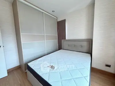 Modern bedroom with sleek wardrobe and comfortable bed in a stylish apartment.