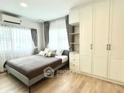 Spacious bedroom with modern design and ample natural light