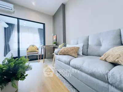 Modern living room with cozy sofa and stylish decor in a bright apartment.
