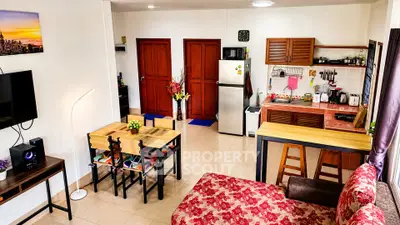 Charming open-layout living room and kitchen with vibrant decor and modern appliances.