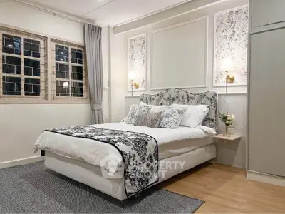 Elegant bedroom with stylish decor and cozy ambiance, featuring a comfortable bed and chic lighting.