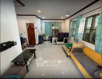 Spacious living room with modern decor and large windows for natural light.