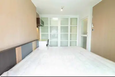 Spacious bedroom with modern sliding doors and ample natural light.