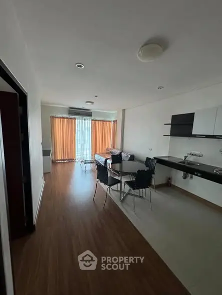 Spacious modern living room with dining area and large windows.