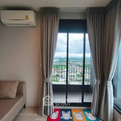 Charming living room with balcony offering stunning city views, perfect for relaxation and enjoying the skyline.