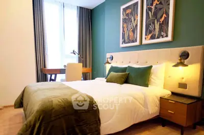 Stylish bedroom with modern decor and natural light, featuring a cozy bed and elegant artwork.