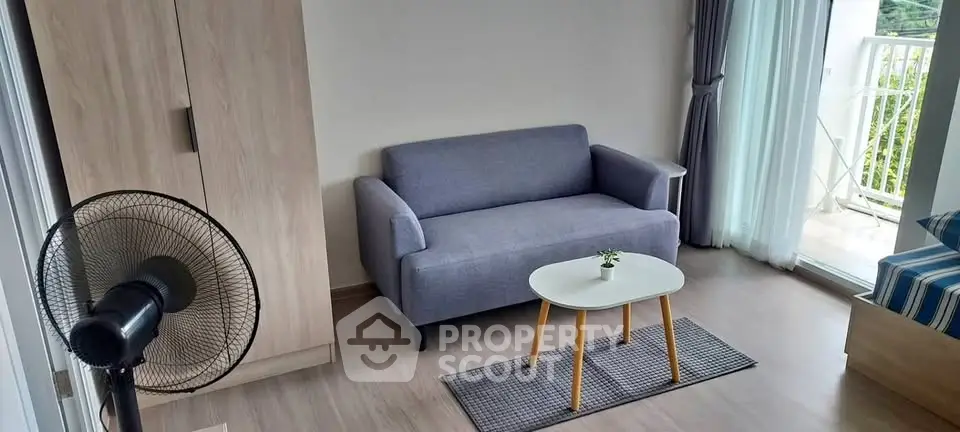 Cozy living room with modern sofa and balcony access