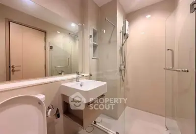 Modern bathroom with glass shower and sleek fixtures