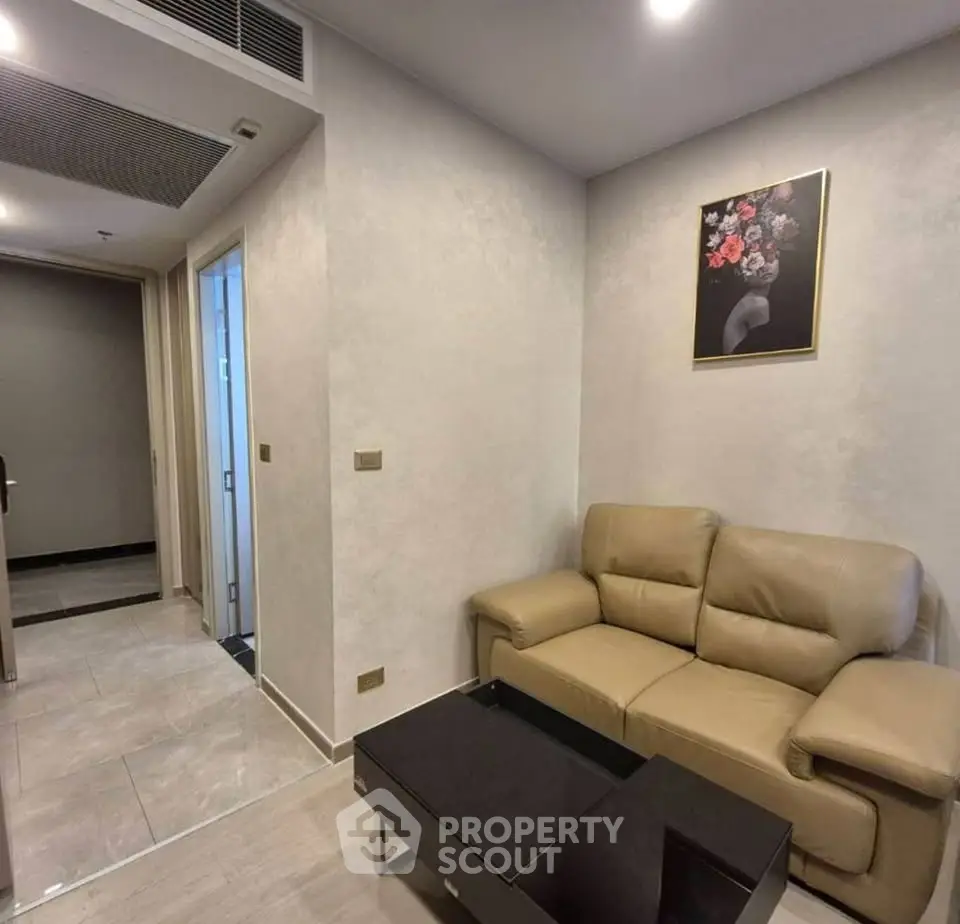 Modern living room with beige sofa and floral artwork, perfect for cozy relaxation.