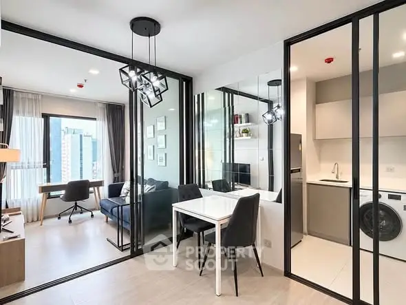 Modern apartment with open layout, featuring a stylish living room, dining area, and compact kitchen with washer.