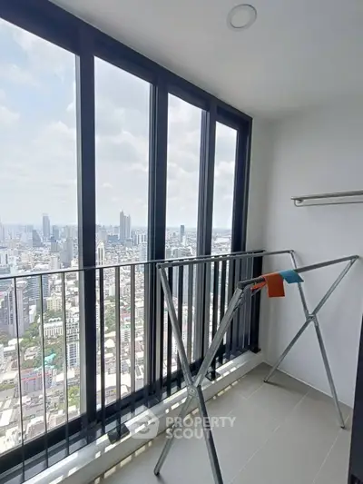 Stunning high-rise balcony with panoramic city views and modern railing.