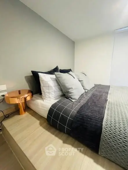 Modern bedroom with stylish decor and cozy bedding in a contemporary home.