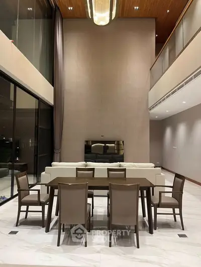 Luxurious modern living room with high ceilings and elegant dining area, perfect for sophisticated gatherings.