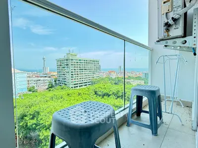 Stunning balcony view with cityscape and lush greenery, perfect for relaxation.