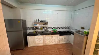 Spacious kitchen with modern appliances and sleek design, perfect for culinary enthusiasts.