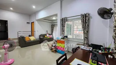 Spacious living room with modern decor and ample natural light