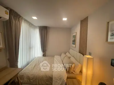 Cozy bedroom with elegant decor and natural light, featuring a comfortable bed and stylish furnishings.