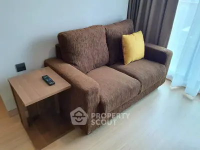 Cozy living room with brown sofa and side table, perfect for relaxation.