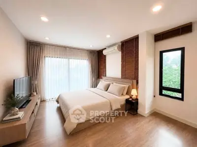Spacious modern bedroom with natural light and elegant decor