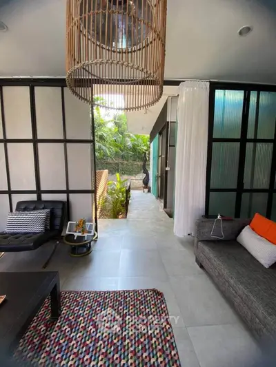 Stylish modern living room with chic decor and garden view