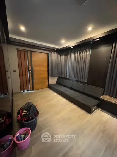 Modern living room with sleek design and cozy ambiance, featuring stylish furniture and elegant lighting.