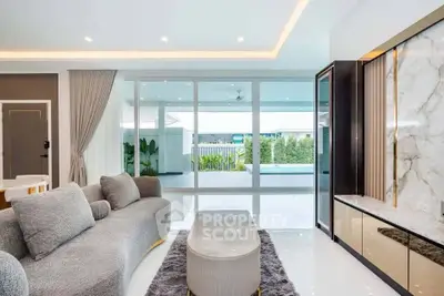 Luxurious living room with pool view and modern decor