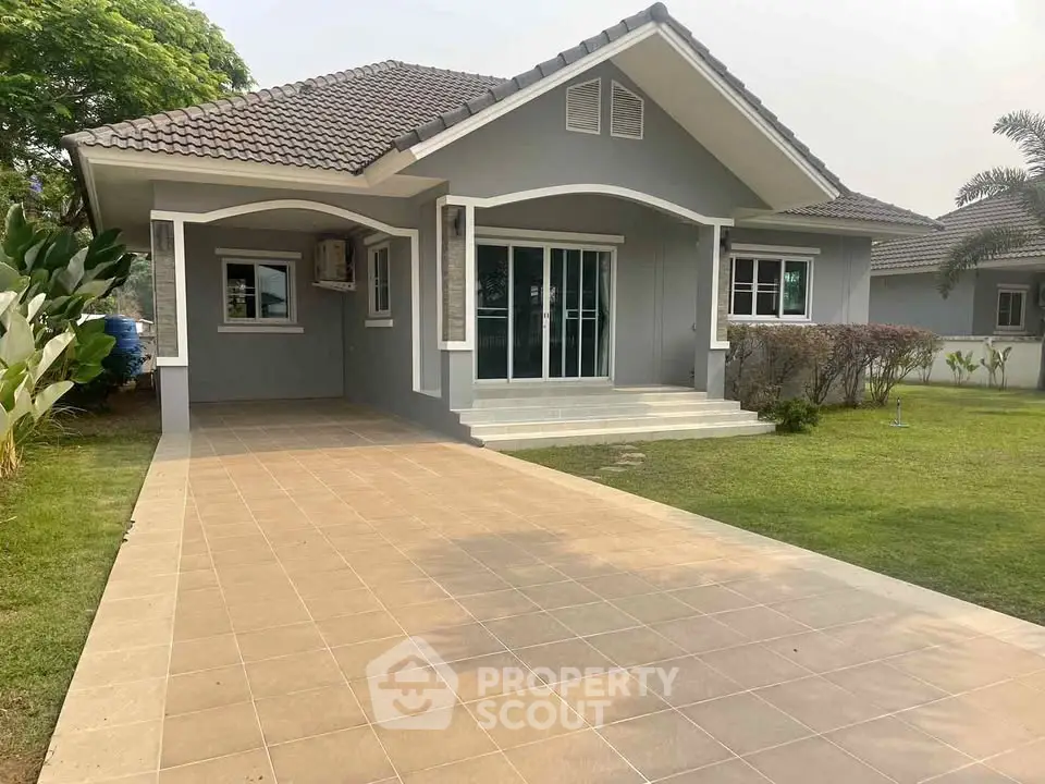 Charming single-story house with spacious driveway and lush green lawn