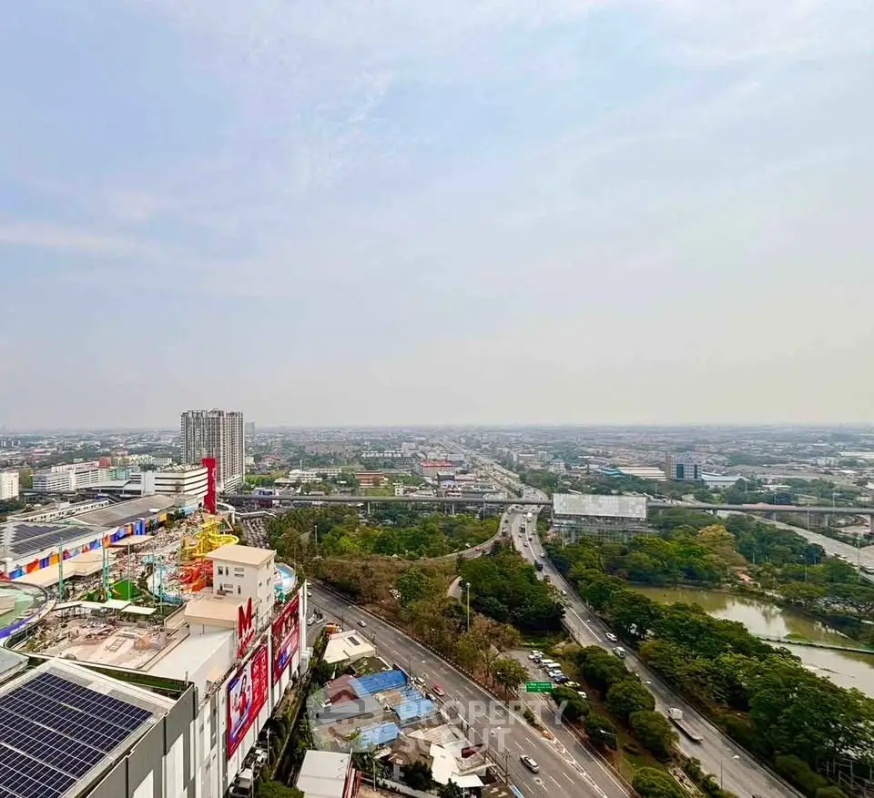 Stunning aerial view of urban landscape with roads, buildings, and lush greenery, perfect for real estate investment.