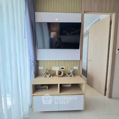 Modern living room with wall-mounted TV and stylish decor