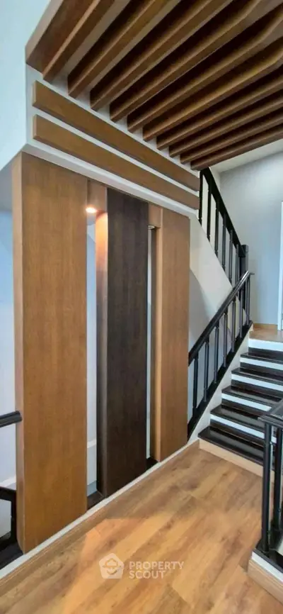 Modern staircase with wooden accents and sleek design in a contemporary home