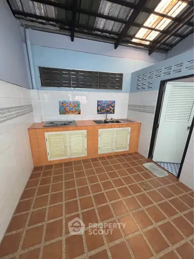 Charming kitchen with tiled floor and dual sinks, perfect for culinary enthusiasts.