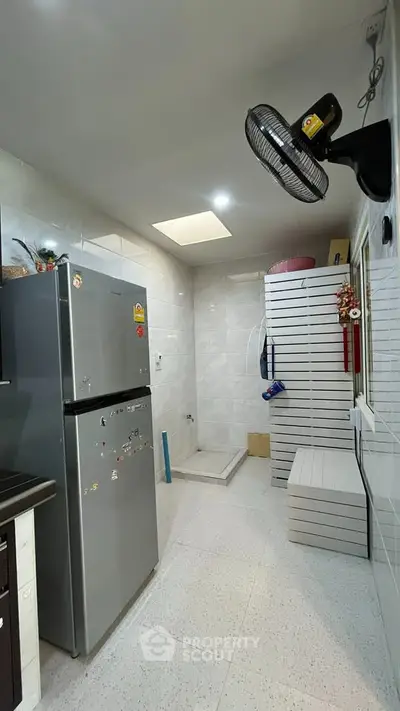 Modern kitchen with sleek appliances and ample storage space