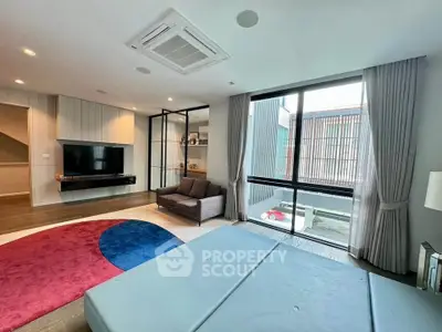 Spacious modern living room with large windows and stylish decor