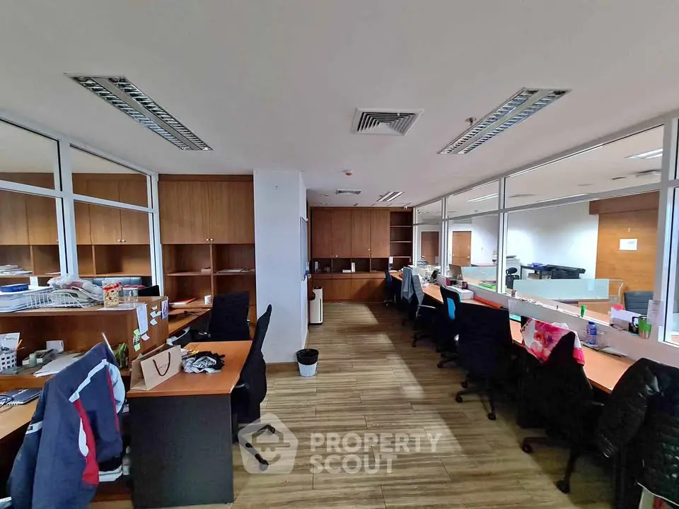 Spacious office interior with modern workstations and wooden flooring