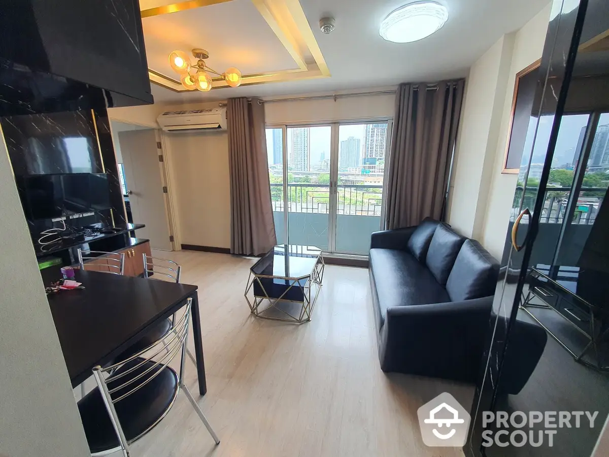 Spacious modern living room with sleek black furniture and large windows offering an urban view, perfect for comfortable city living.