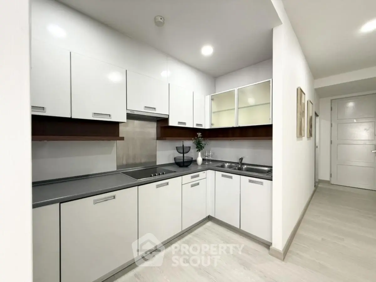 Modern kitchen with sleek white cabinets and integrated appliances