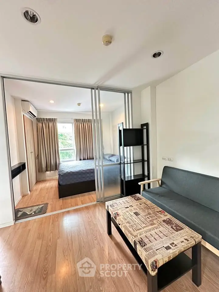 Modern studio apartment with sliding glass doors and stylish furnishings.