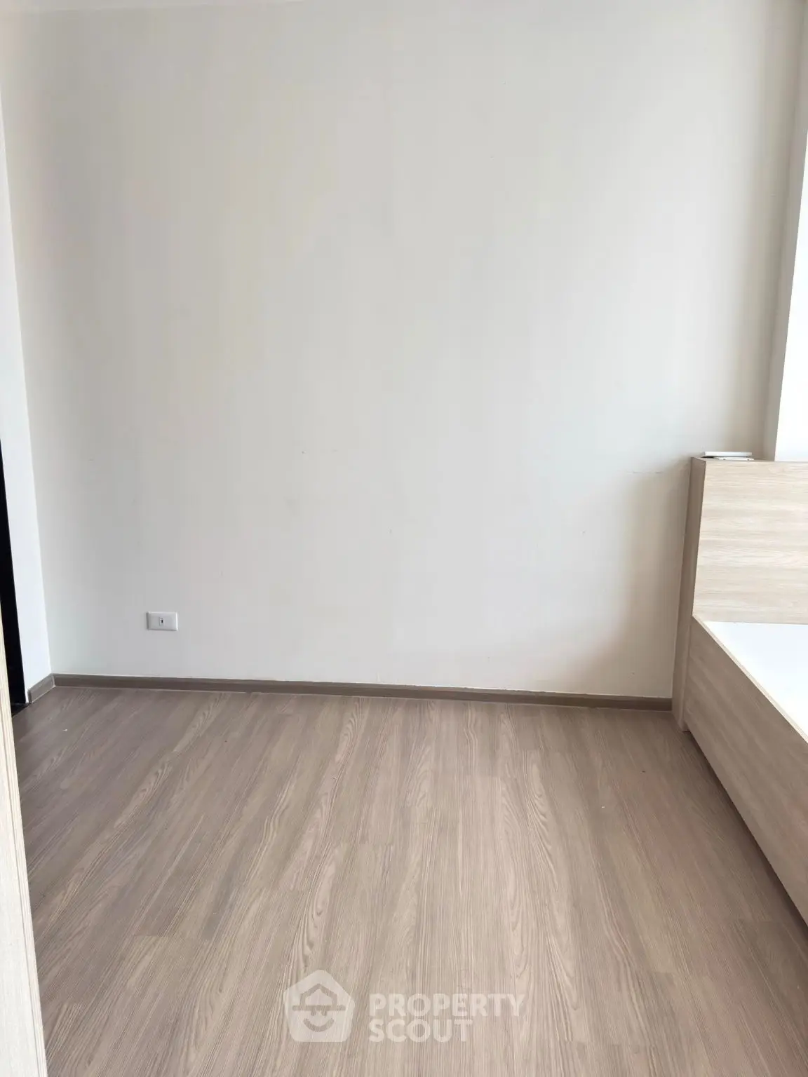 Minimalist bedroom with wooden flooring and modern bed frame