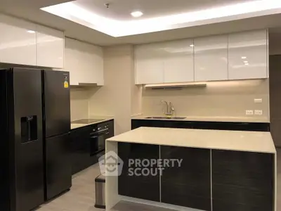 Modern kitchen with sleek cabinetry and island in a contemporary apartment