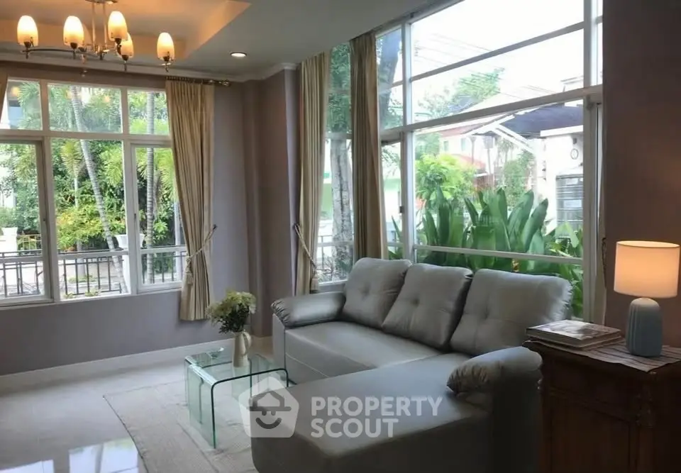 Spacious living room with large windows and modern decor